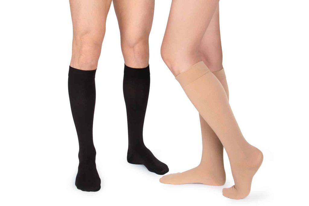 Two people wearing black and beige compression socks